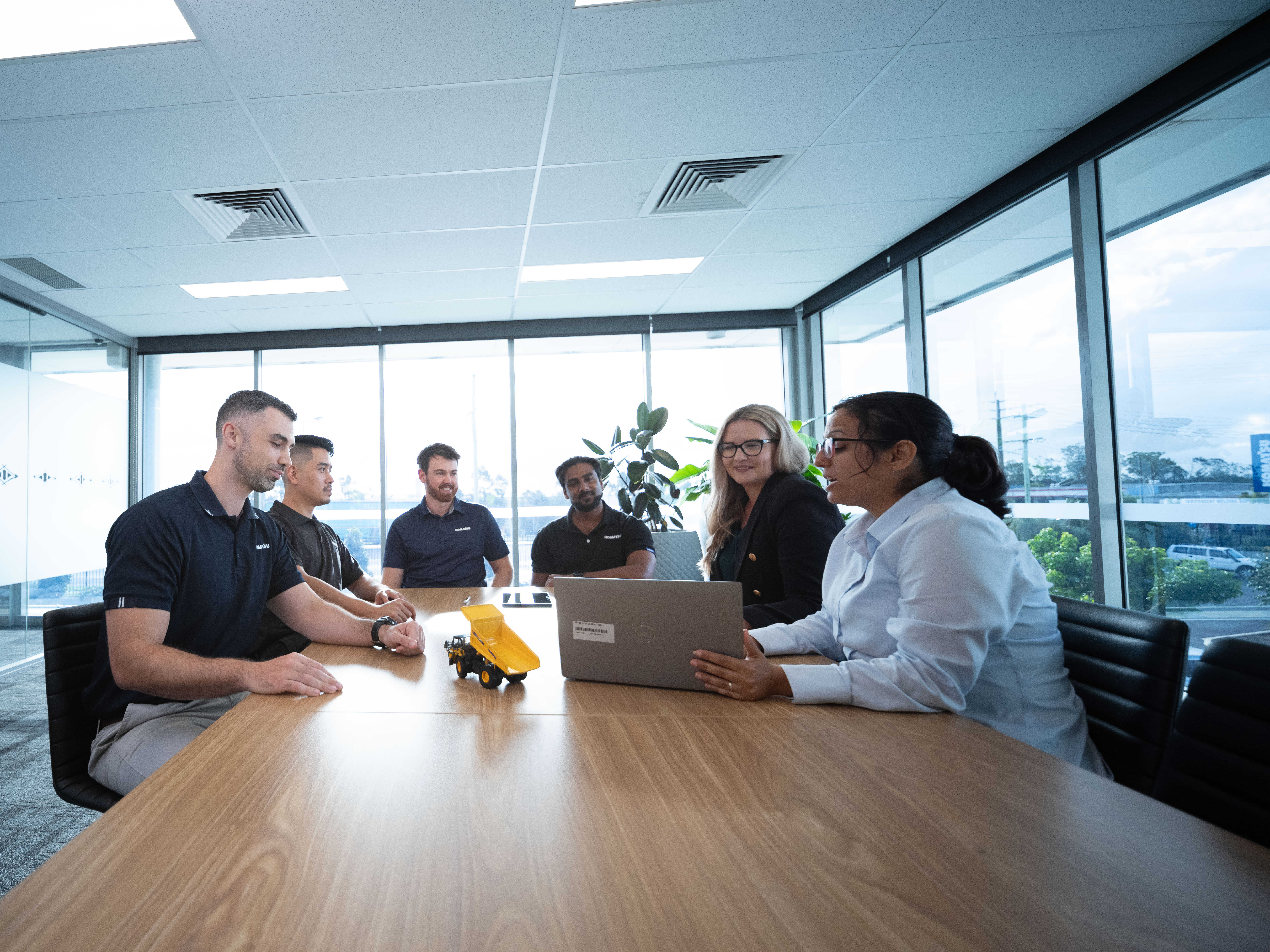 Employees sitting at a table in a meeting