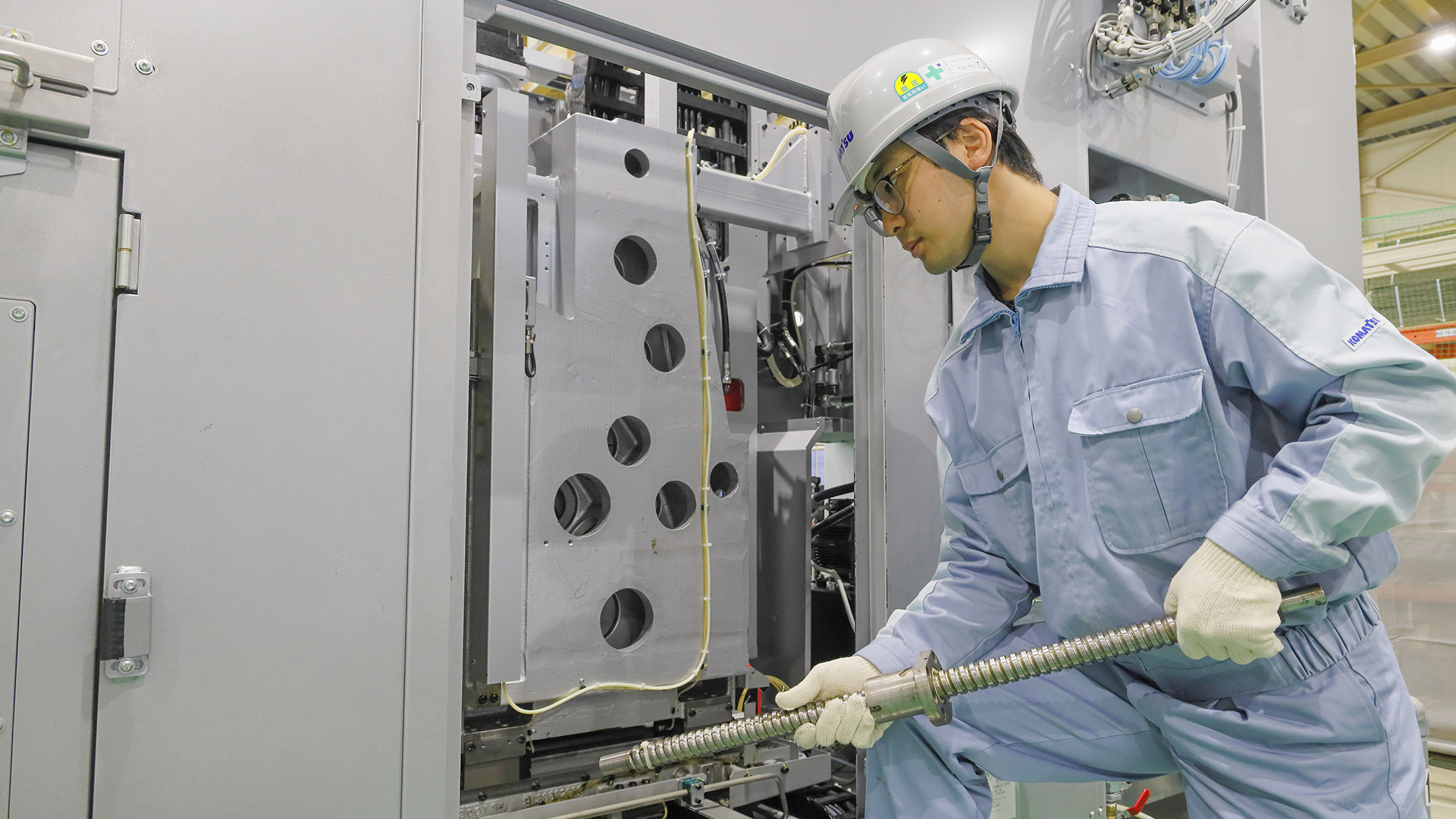 Technician operating industrial machinery indoors