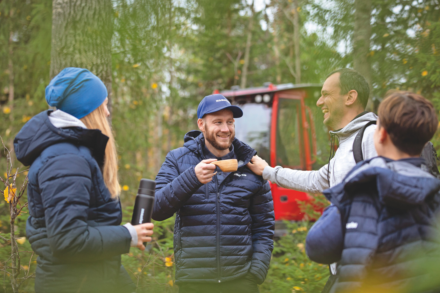 Men talking in front of Komatsu equipment