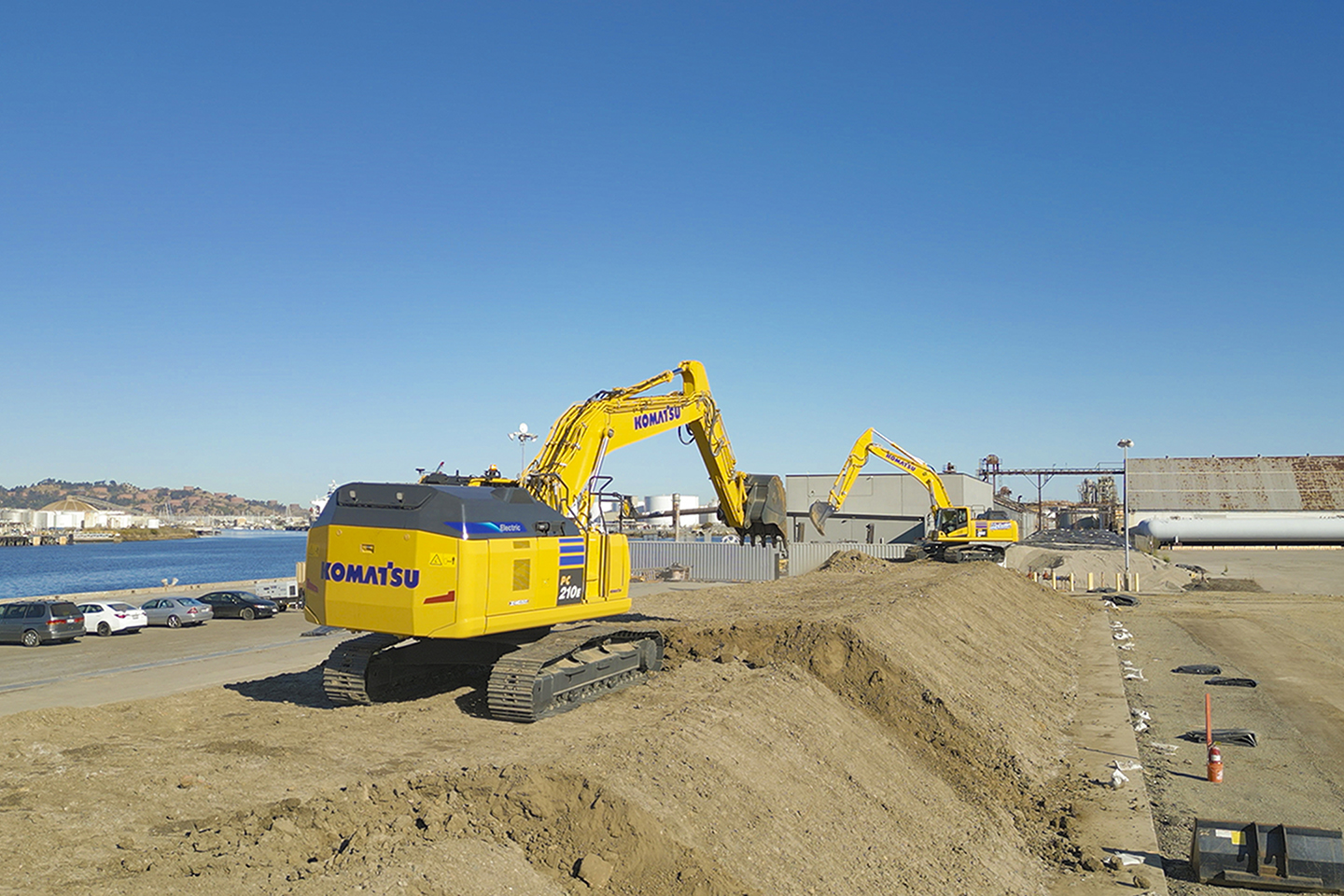 Komatsu electric and hybrid excavators on a construction site.