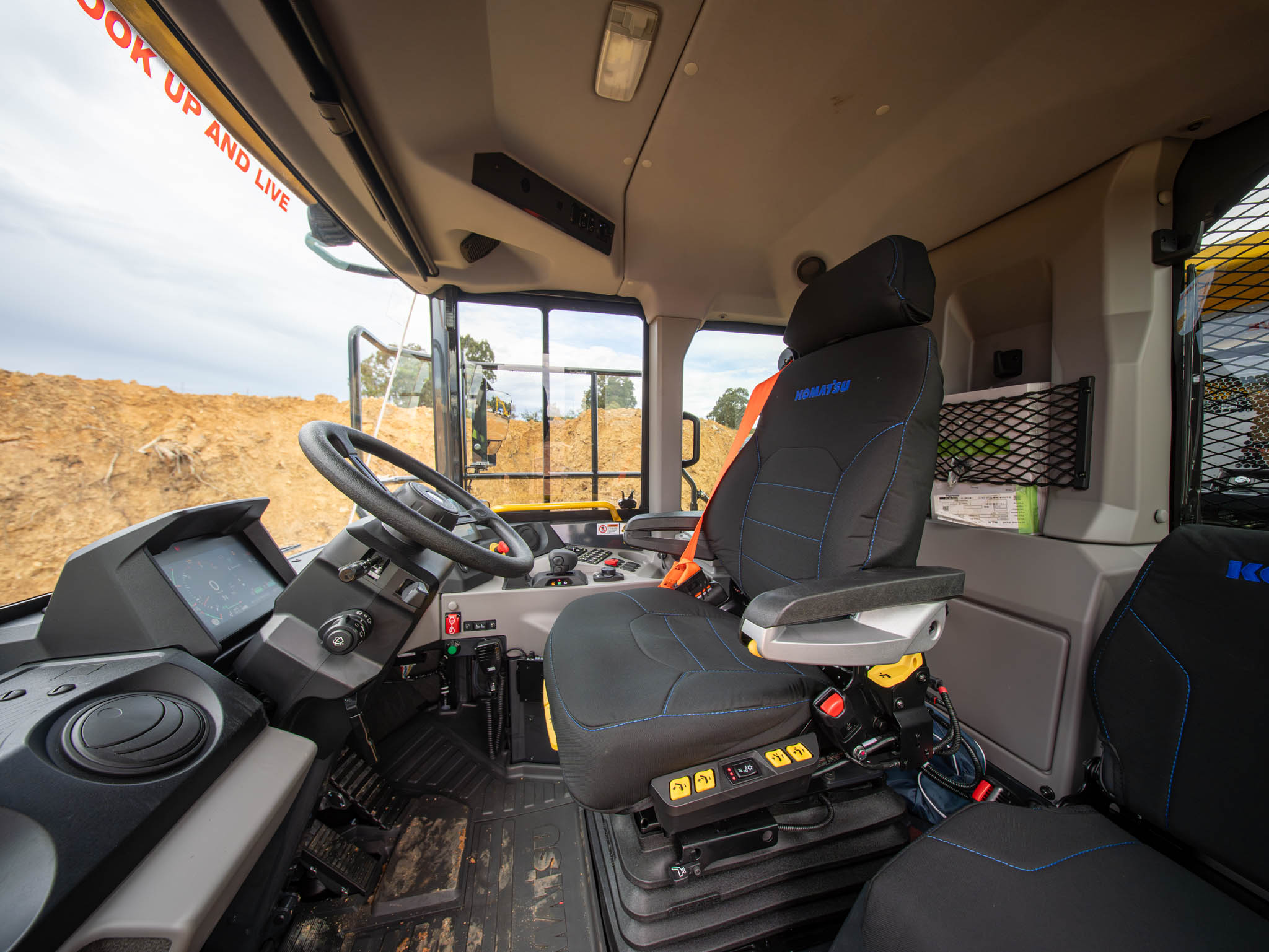 An inside view in the cab of a Komatsu dump truck.