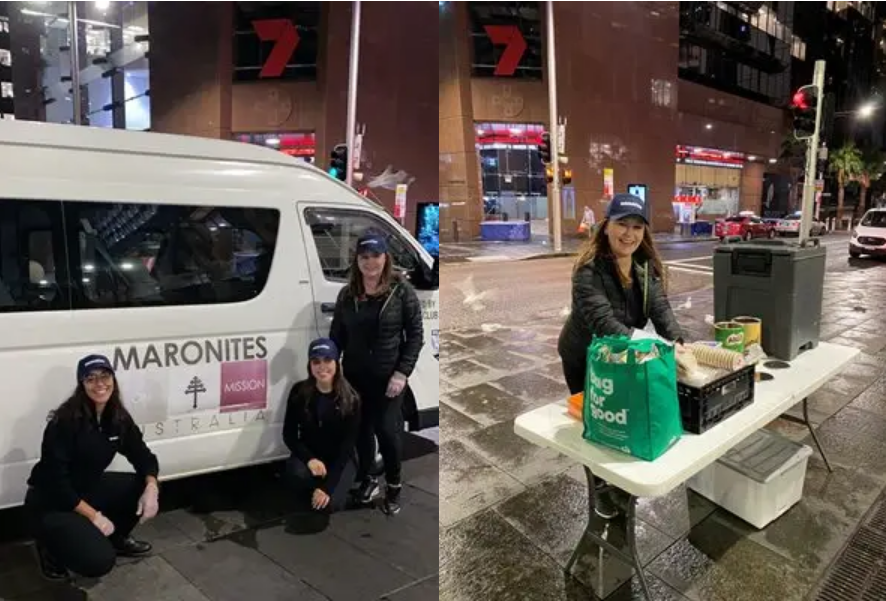 a person standing behind a table with food items and supplies on a city street at night