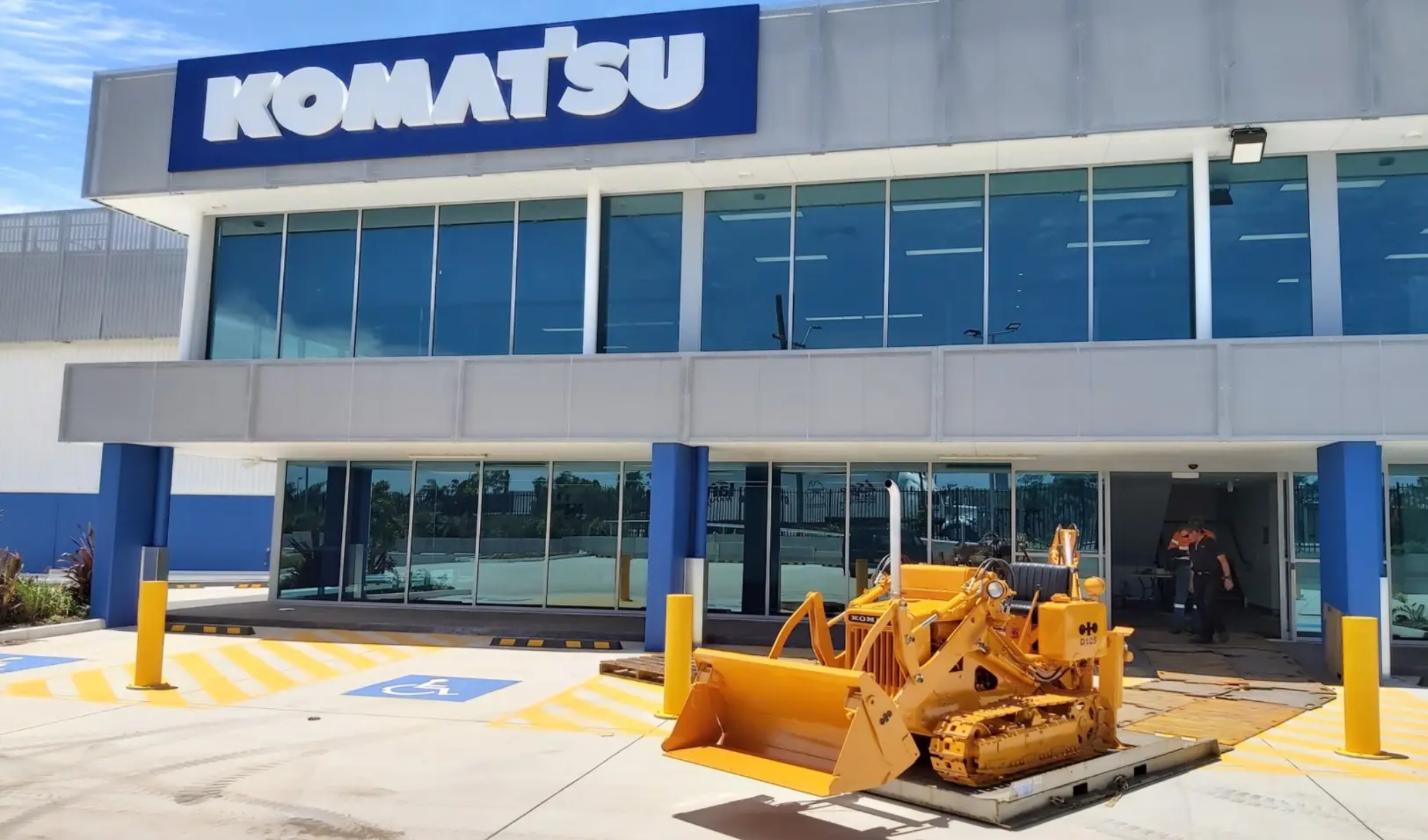 D10S-1 restored loader in front of Komatsu building