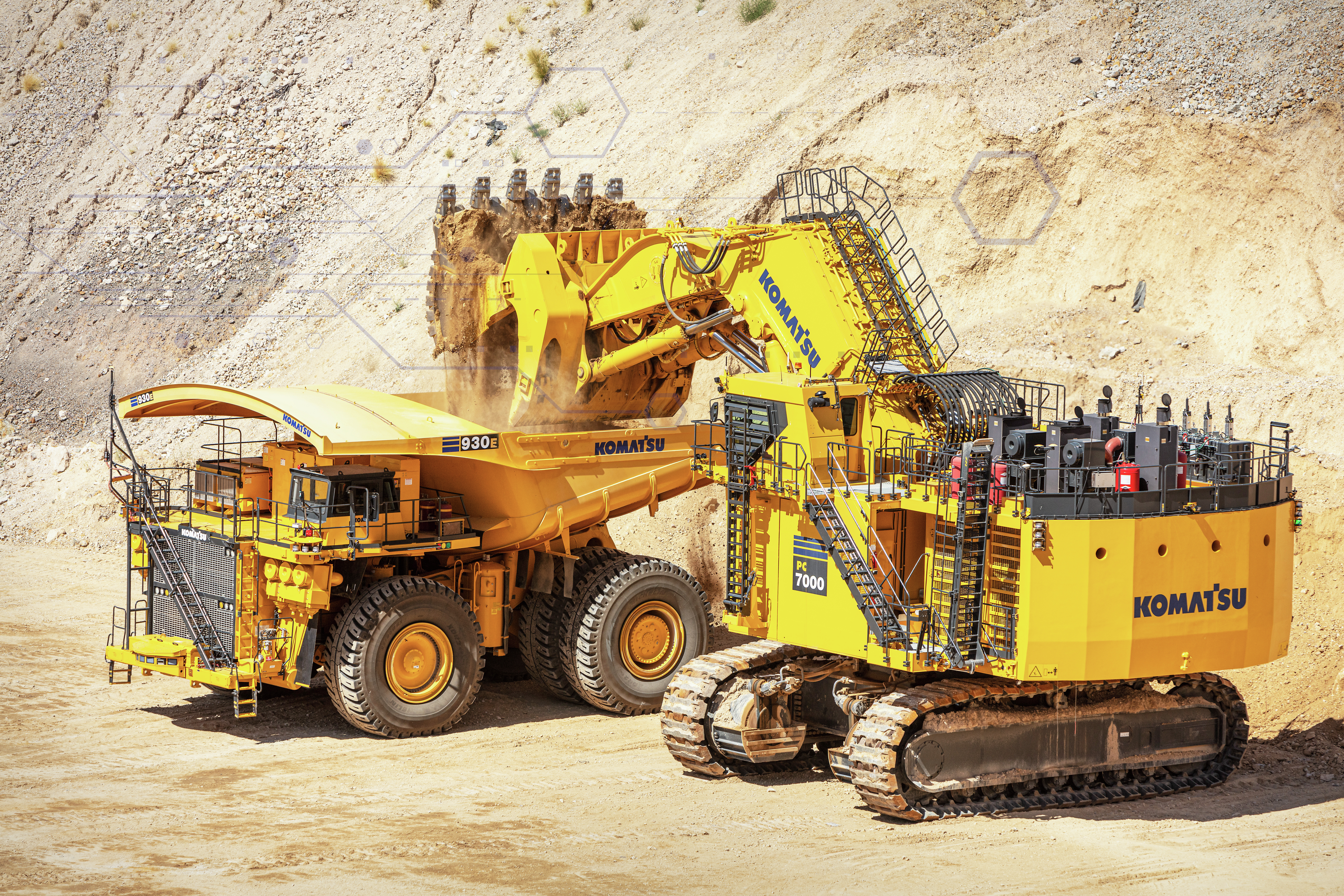 Komatsu mining excavator and dump truck in quarry