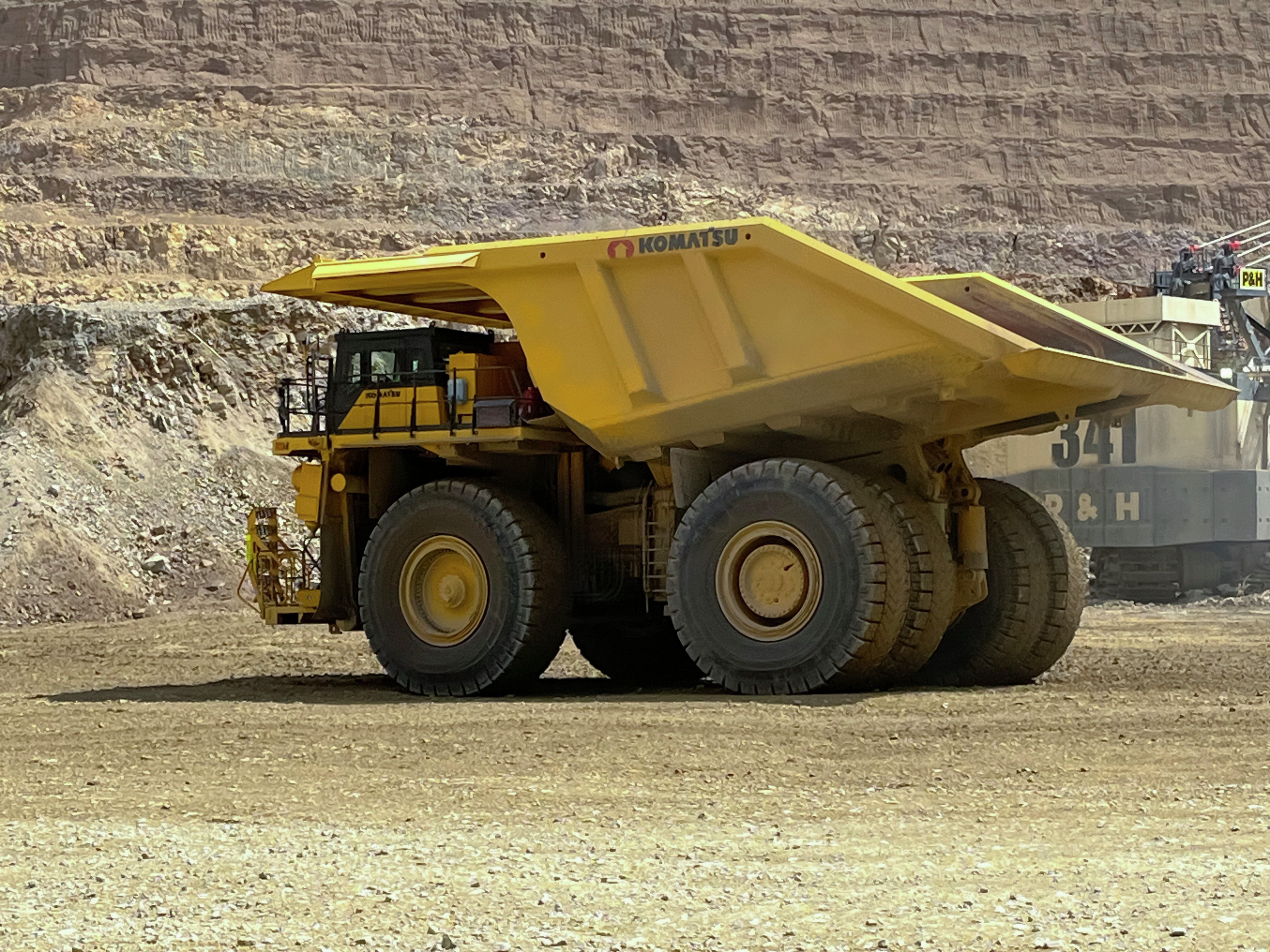 Large yellow mining dump truck in quarry