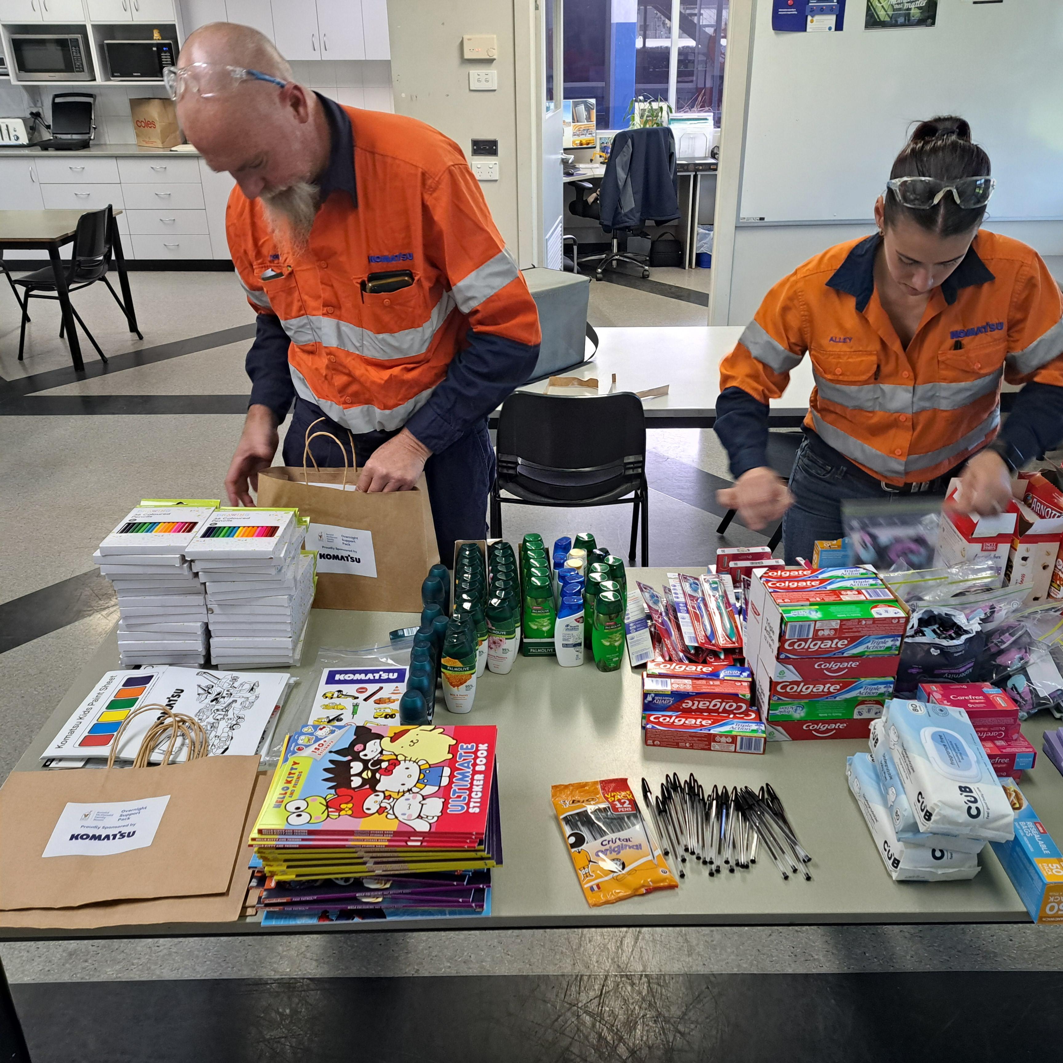 Workers organizing supplies on a table