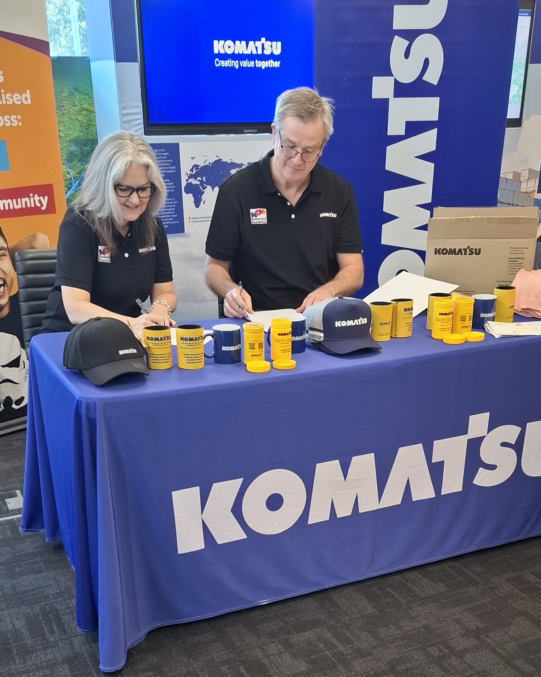 Komatsu promotional booth with branded items