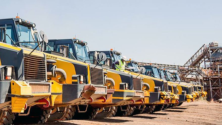 A row of articulated dump truck in a work site in Southern Africa.