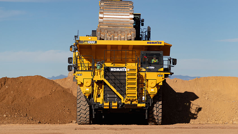 A row of articulated dump truck in a work site in Southern Africa.